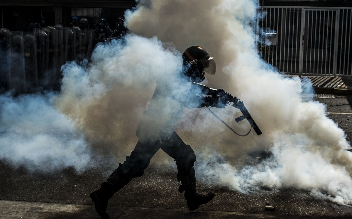 A member of the National Guard cracks down on opposition demonstrators during a march against President Nicolas Maduro, in Caracas on April 26, 2017.