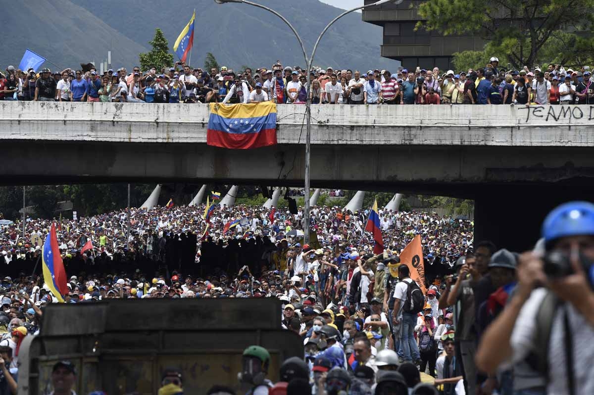Opposition activists march during a protest against Venezuelan President Nicolas Maduro, in Caracas on May 3, 2017.