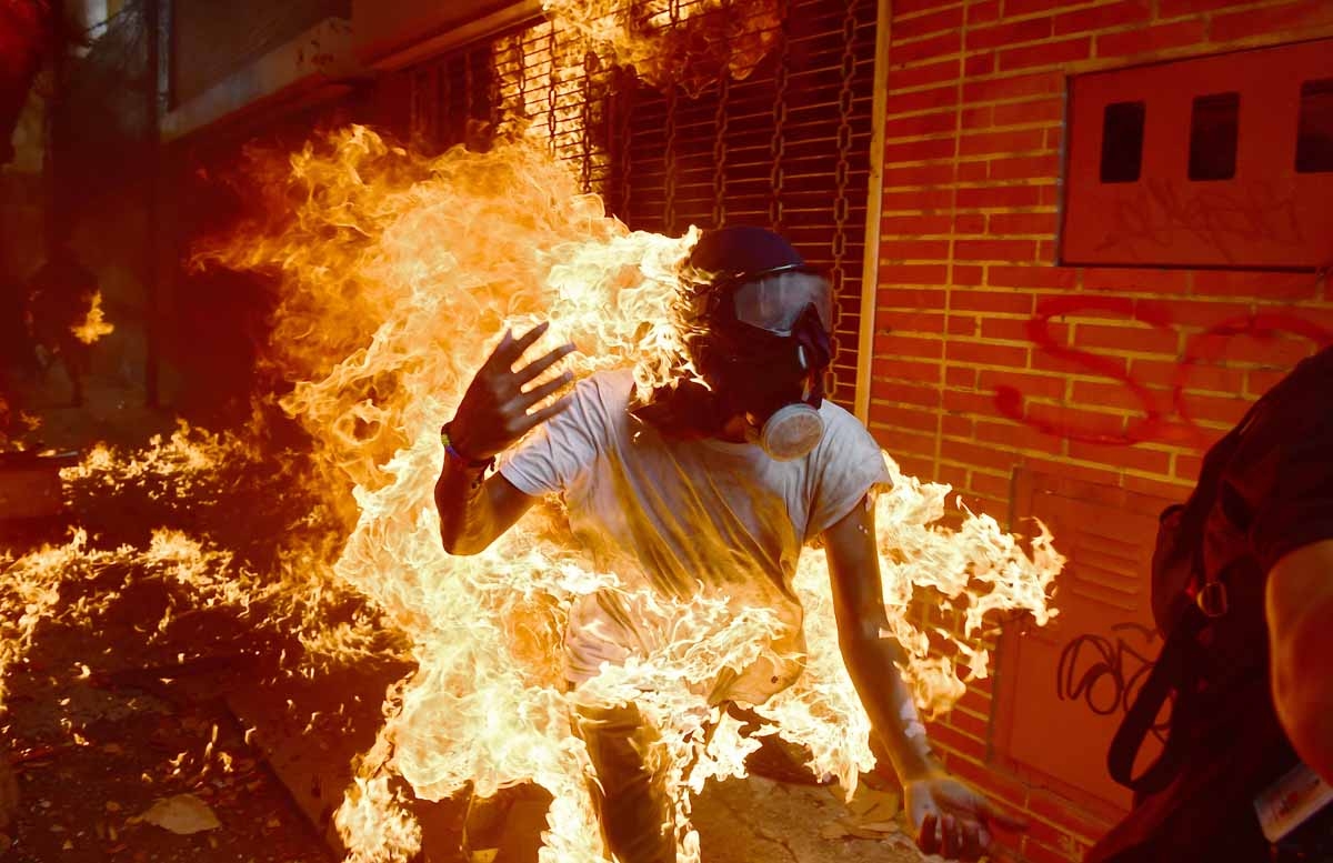 A demonstrator catches fire during clashes with riot police within a protest against Venezuelan President Nicolas Maduro, in Caracas on May 3, 2017. Venezuela's angry opposition rallied Wednesday vowing huge street protests against President Nicolas Madur