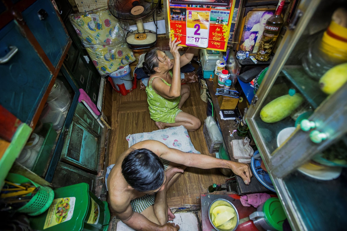 Kha Tu Ngoc and her husband Pham Huy Duc prepare for dinner in their two-square-meter house in Ho Chi Minh City on May 2, 2018.
