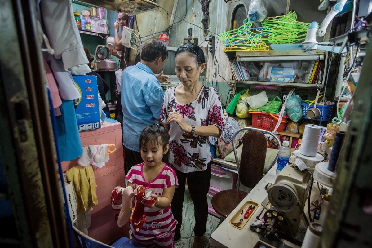 Nguyen Thi Kim Ngoc and her husband Nguyen Van Truong are seen with their granddaughter in their 6.7-square-metre home in Ho Chi Minh City on May 3, 2018.