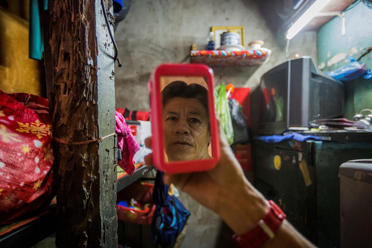 Pham Quoc Cong poses inside his two-square-metre home in Ho Chi Minh City on May 2, 2018.