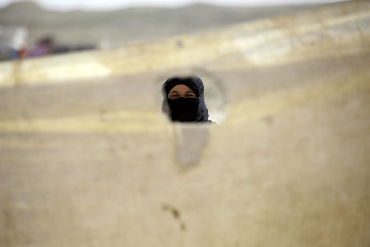 An Iraqi refugee, who fled from Mosul, looks on in a camp in al-Hol, located some 14 kilometers from the Iraqi border in Syriaâs northeastern Hassakeh province, on March 13