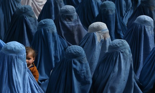 An Afghan woman holds her baby as she and supporters attend the election rally of Afghan presidential candidate Abdullah Abdullah in Jalalabad on February 18, 2014. An Afghan woman holds her baby as she and supporters attend the election rally of Afghan presidential candidate Abdullah Abdullah in Jalalabad on February 18, 2014.