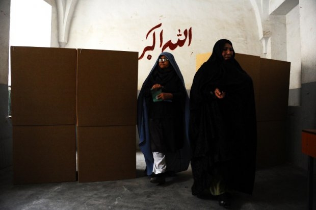 Afghan women leave voting booths after filling their ballots at a polling station in the northwestern city of Herat on April 5, 2014. Afghan women leave voting booths after filling their ballots at a polling station in the northwestern city of Herat on April 5, 2014.