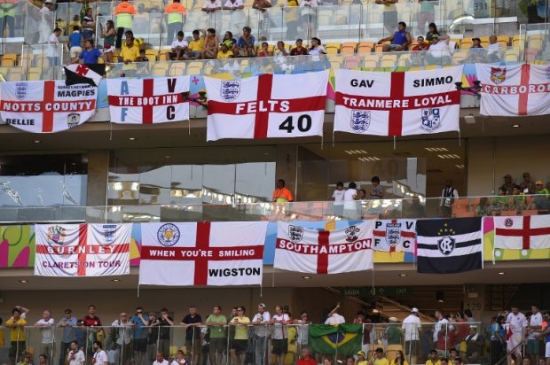 England fans hang flags as they await the kick-off of a Group D football match between England and Italy at the Amazonia Arena in Manaus during the 2014 FIFA World Cup on June 14, 2014. England fans hang flags as they await the kick-off of a Group D football match between England and Italy at the Amazonia Arena in Manaus during the 2014 FIFA World Cup on June 14, 2014.