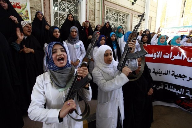 Iraqi Shiite women hold their weapons as they gather in Najaf to show their willingness to join Iraqi security forces in the fight against jihadist militants. Iraqi Shiite women hold their weapons as they gather in Najaf to show their willingness to join Iraqi security forces in the fight against jihadist militants.