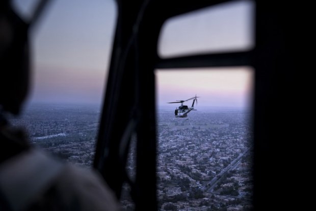 A picture taken on board a helicopter shows an US State Department helicopter flying over the Iraqi capital Baghdad as it transports Kerry. A picture taken on board a helicopter shows an US State Department helicopter flying over the Iraqi capital Baghdad as it transports Kerry.