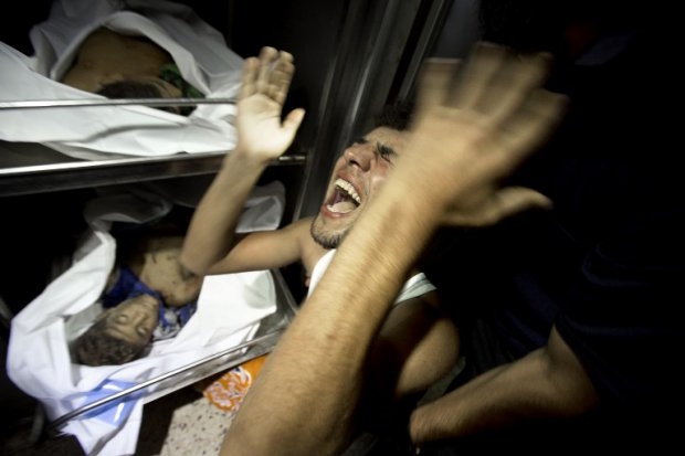 Relatives of four Palestinian boys, all from the Bakr family, mourn over the body of one of the boys at the morgue of al-Shifa hospital in Gaza City, on July 16, 2014. (AFP Photo/Mahmud Hams) Relatives of four Palestinian boys, all from the Bakr family, mourn over the body of one of the boys at the morgue of al-Shifa hospital in Gaza City, on July 16, 2014. (AFP Photo/Mahmud Hams)