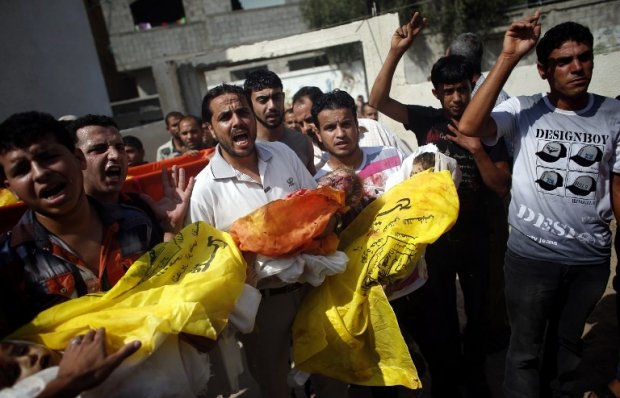Palestinian relatives carry the bodies of three kids, who were among eight members of the same family killed in an Israeli strike, during their funeral on July 19, 2014 in Beit Lahia, north of the Gaza strip. Palestinian relatives carry the bodies of three kids, who were among eight members of the same family killed in an Israeli strike, during their funeral on July 19, 2014 in Beit Lahia, north of the Gaza strip.