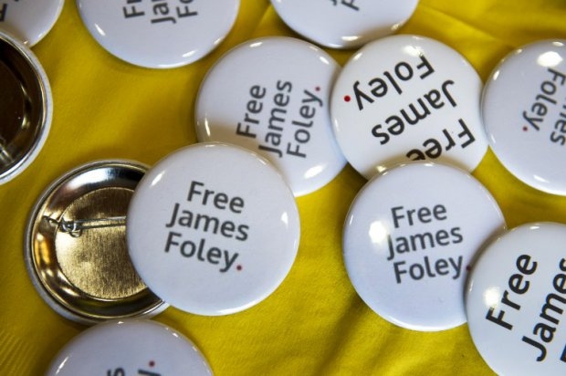 Buttons in support of James Foley are displayed during a panel discussion about the importance and dangers of reporting on world conflicts at a Free James Foley event on May 3, 2013 in Boston. Buttons in support of James Foley are displayed during a panel discussion about the importance and dangers of reporting on world conflicts at a Free James Foley event on May 3, 2013 in Boston.