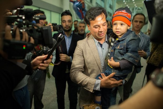 Bashir Mirzad holds his nephew Abuzar Ahmad as he is greeted by nearly 100 family and well wishers at Pearson Airport in Toronto, Ontario, Canada, April 30, 2014 Bashir Mirzad holds his nephew Abuzar Ahmad as he is greeted by nearly 100 family and well wishers at Pearson Airport in Toronto, Ontario, Canada, April 30, 2014
