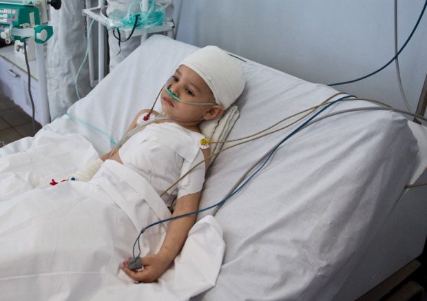 Abuzar Ahmad lies on a bed at a local hospital in Kabul on March 25, 2014 Abuzar Ahmad lies on a bed at a local hospital in Kabul on March 25, 2014