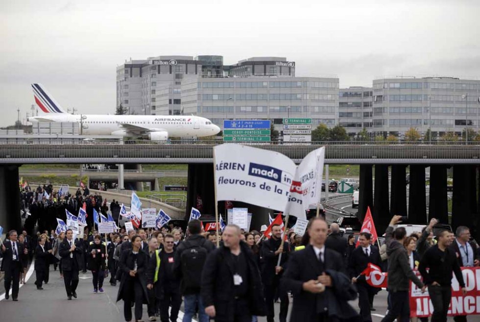 Air France employees march through the airport, protesting planned job cuts. Air France employees march through the airport, protesting planned job cuts.