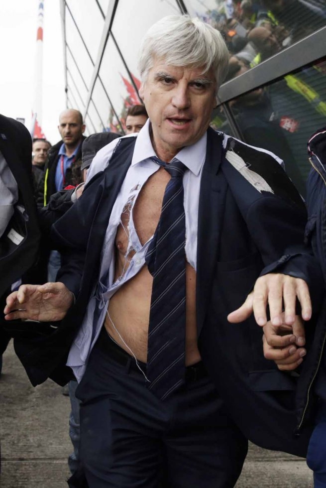 Senior Air France executive Pierre Plissonnier, his clothes torn to shreds, flees from a mob of employees unhappy about planned job cuts. Senior Air France executive Pierre Plissonnier, his clothes torn to shreds, flees from a mob of employees unhappy about planned job cuts.