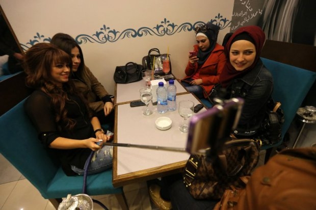Syrian women take selfies at Fairuz restaurant in Aleppo's government-held Mogambo neighourhood on November 15, 2014 Syrian women take selfies at Fairuz restaurant in Aleppo's government-held Mogambo neighourhood on November 15, 2014