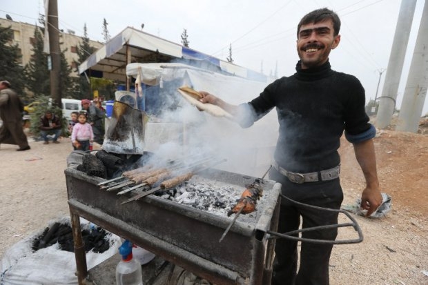 A Syrian man prepares traditional kebab on a street on the government-held side of Aleppo on November 16, 2014 A Syrian man prepares traditional kebab on a street on the government-held side of Aleppo on November 16, 2014