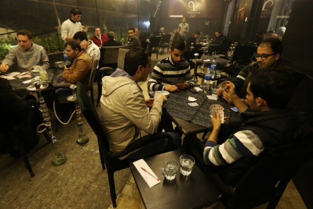 Syrian men play cards at a cafe in the Mogambo neighbourhood on the government-held side of Aleppo on November 15, 2014 Syrian men play cards at a cafe in the Mogambo neighbourhood on the government-held side of Aleppo on November 15, 2014