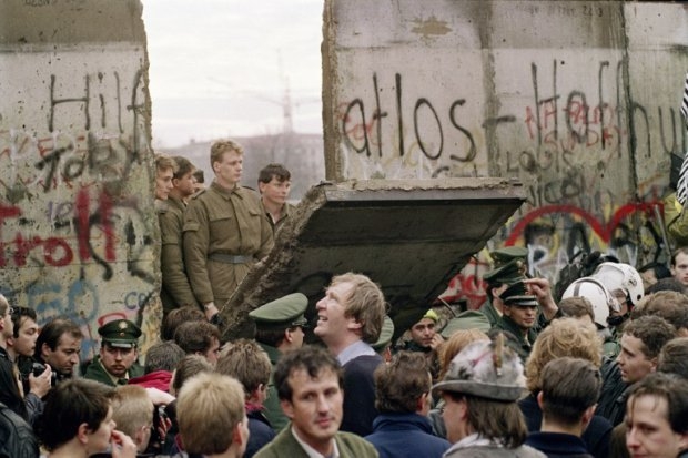East German border guards demolish a section of the Berlin Wall early November 11, 1989 East German border guards demolish a section of the Berlin Wall early November 11, 1989