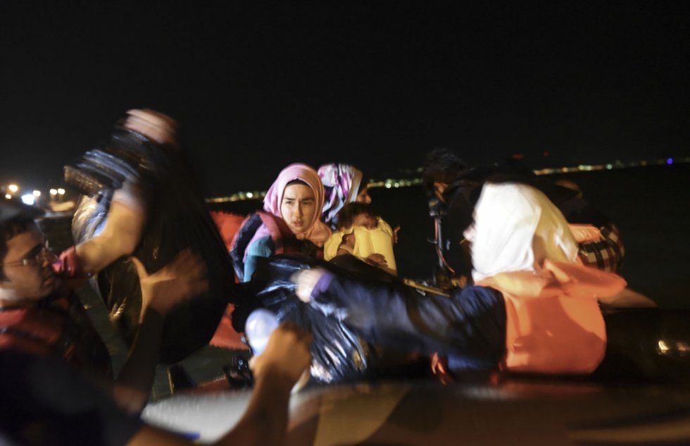 "Migrants board a dinghy in Bodrum to reach Kos on August 20, 2015 "Migrants board a dinghy in Bodrum to reach Kos on August 20, 2015