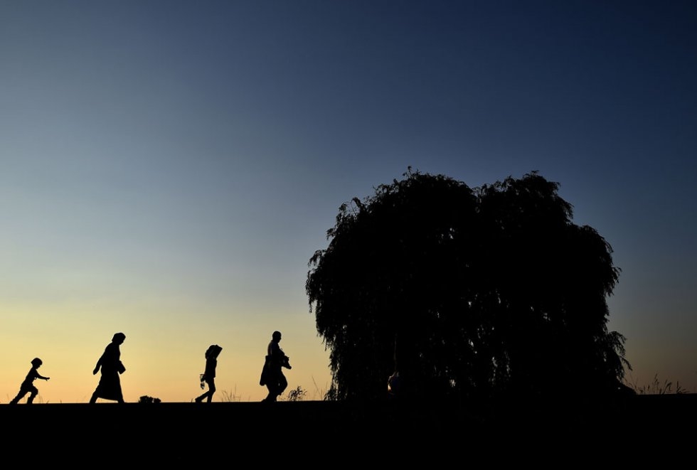 Syrian refugees and migrants along a railway line as they try to cross from Serbia into Hungary near Horgos on September 1, 2015 Syrian refugees and migrants along a railway line as they try to cross from Serbia into Hungary near Horgos on September 1, 2015