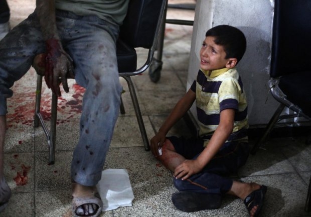 A Syrian boy cries as he looks at his wounded father on September 9, 2014 A Syrian boy cries as he looks at his wounded father on September 9, 2014