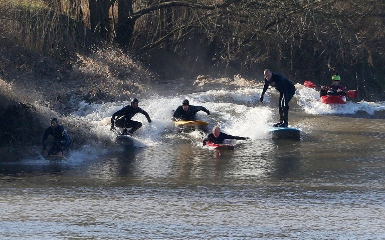 Surfers ride the Severn bore at Minsterworth, southwest England on March 21, 2015 Surfers ride the Severn bore at Minsterworth, southwest England on March 21, 2015