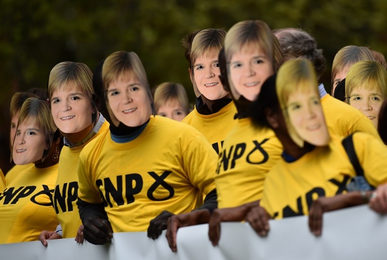 Conservative Party supporters wear masks depicting First Minister of Scotland and SNP Leader Nicola Sturgeon, in London on May 1, 2015, to highlight their projected outcome of an SNP and Labour coalition government Conservative Party supporters wear masks depicting First Minister of Scotland and SNP Leader Nicola Sturgeon, in London on May 1, 2015, to highlight their projected outcome of an SNP and Labour coalition government