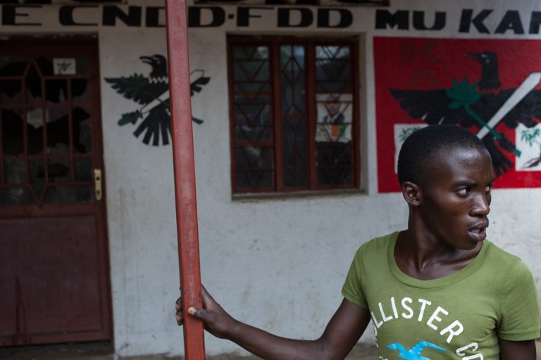 A member of the Imbonerakure, the youth wing of Burundi's CNDD-FDD ruling party, outside the local party offices in the Kanyosha neighbourhood of Bujumbura on May 6, 2015 A member of the Imbonerakure, the youth wing of Burundi's CNDD-FDD ruling party, outside the local party offices in the Kanyosha neighbourhood of Bujumbura on May 6, 2015