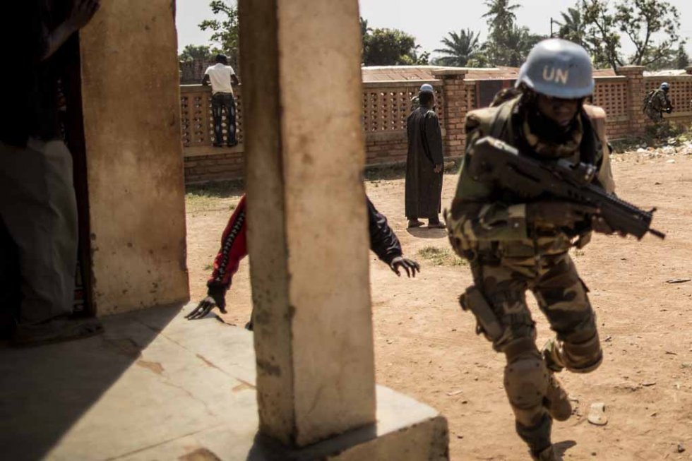 A Senegalese soldier from the UN contingent runs for cover amid gunfire at the Baya Dombia school. A Senegalese soldier from the UN contingent runs for cover amid gunfire at the Baya Dombia school.