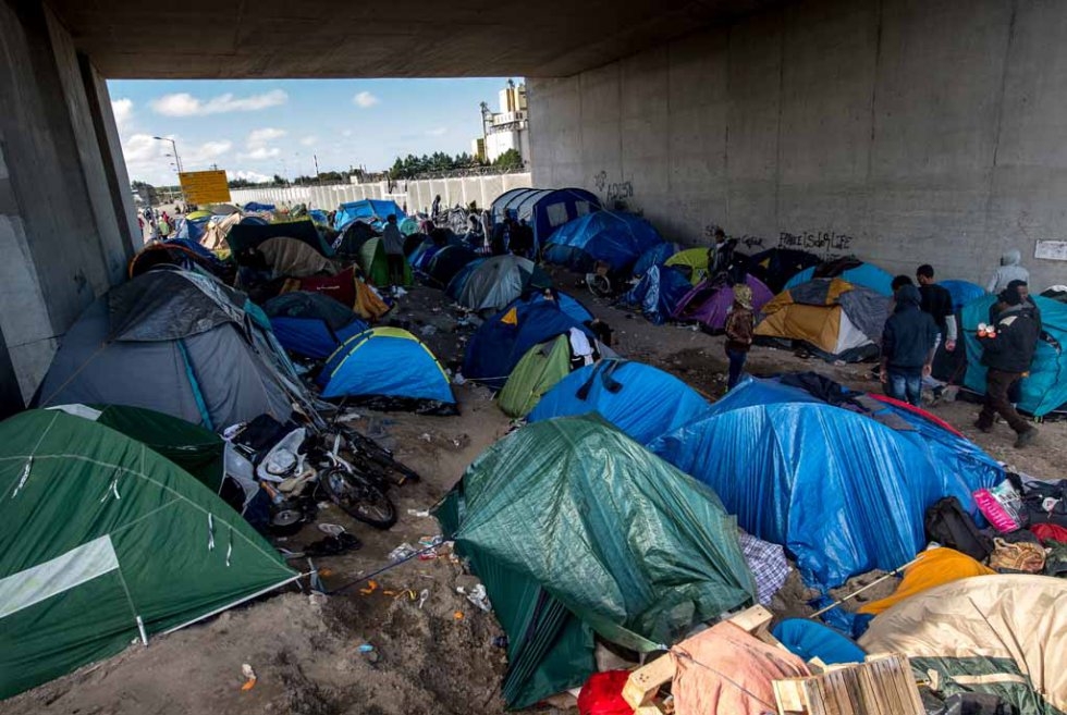 Migrant tents below a bridge Migrant tents below a bridge