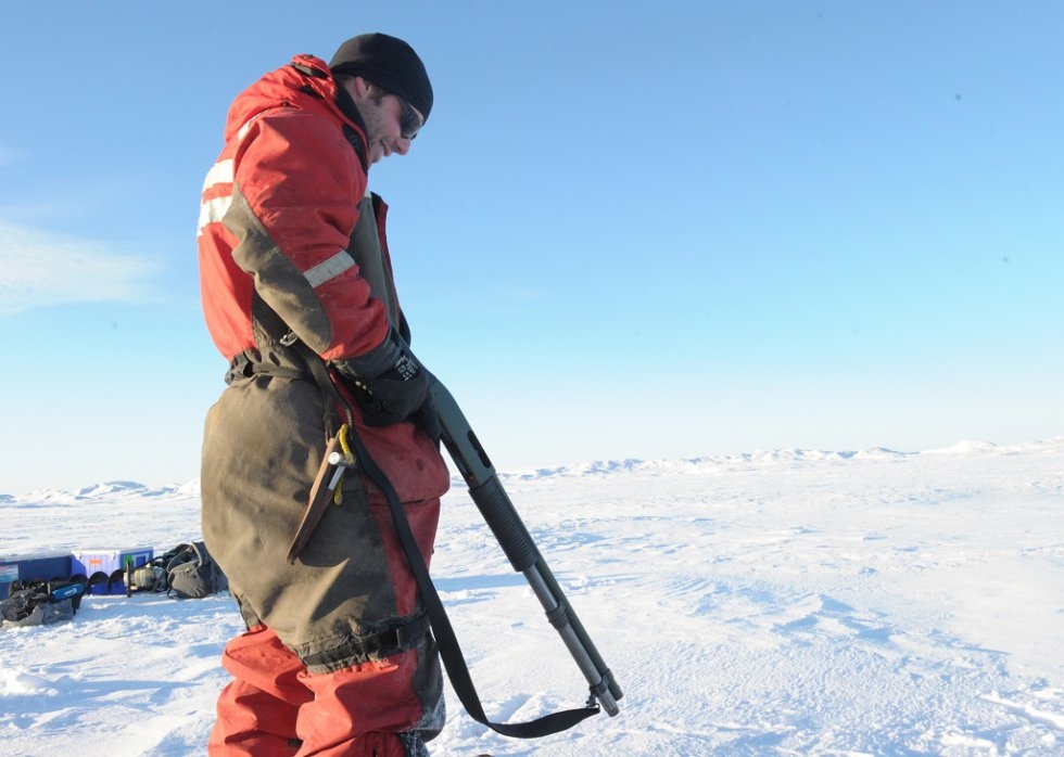 Sailor Hugo Jacques guards against polar bears as scientists work on the ice Sailor Hugo Jacques guards against polar bears as scientists work on the ice