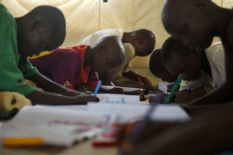 Young Nigerian refugees during an art therapy workshop at a camp near Baga Sola on April 6, 2015 Young Nigerian refugees during an art therapy workshop at a camp near Baga Sola on April 6, 2015