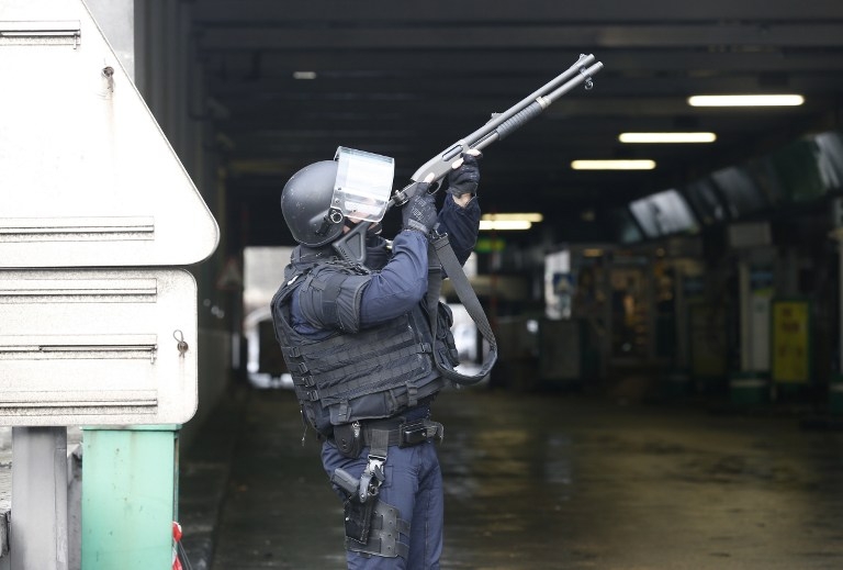 A policeman takes aim at Porte de Vincennes in Paris on January 9, 2015 A policeman takes aim at Porte de Vincennes in Paris on January 9, 2015