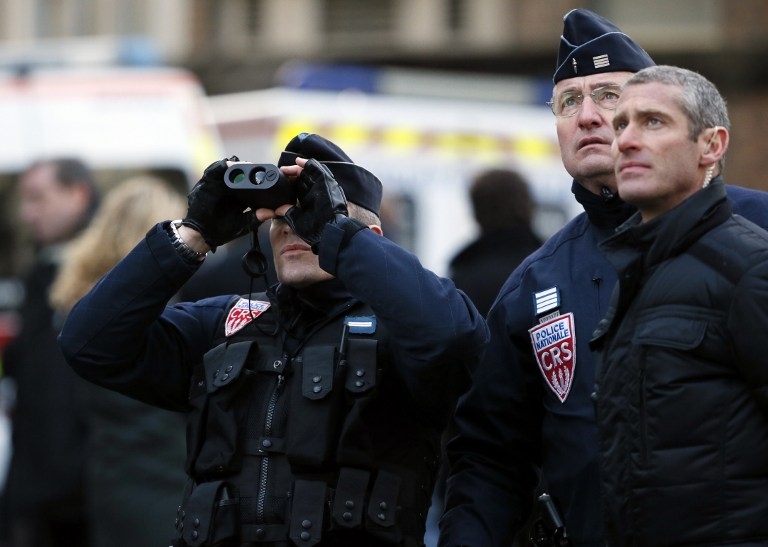 Riot police keep watch during the unity rally in Paris on January 11, 2015 Riot police keep watch during the unity rally in Paris on January 11, 2015