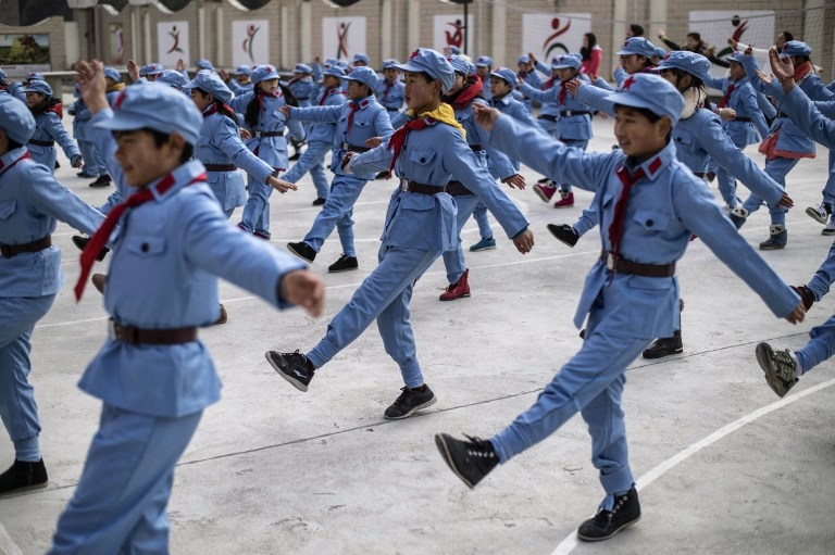 Children march after raising the national flag at the Beichuan Red Army school on January 21, 2015 Children march after raising the national flag at the Beichuan Red Army school on January 21, 2015