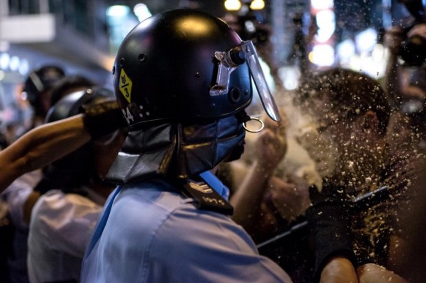 A local Hong Kong journalist (R) is pepper sprayed by police in the Mongkok district of Hong Kong on October 17, 2014 (AFP Photo / Alex Ogle) A local Hong Kong journalist (R) is pepper sprayed by police in the Mongkok district of Hong Kong on October 17, 2014 (AFP Photo / Alex Ogle)
