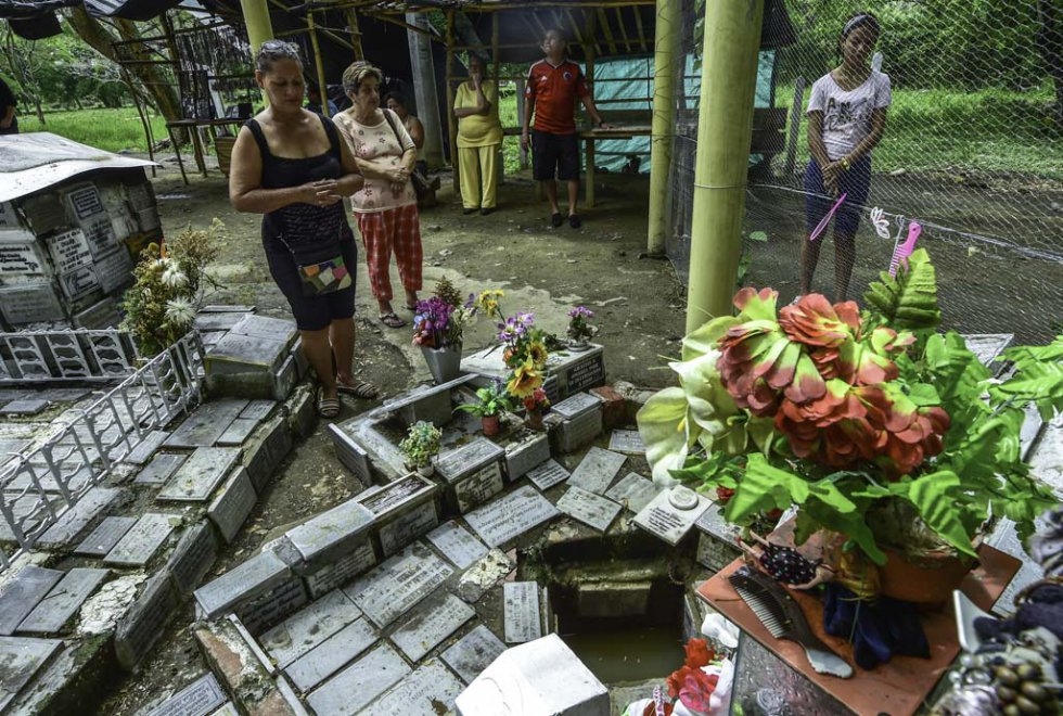 Visitors pray at the site of Omayra's grave. Visitors pray at the site of Omayra's grave.
