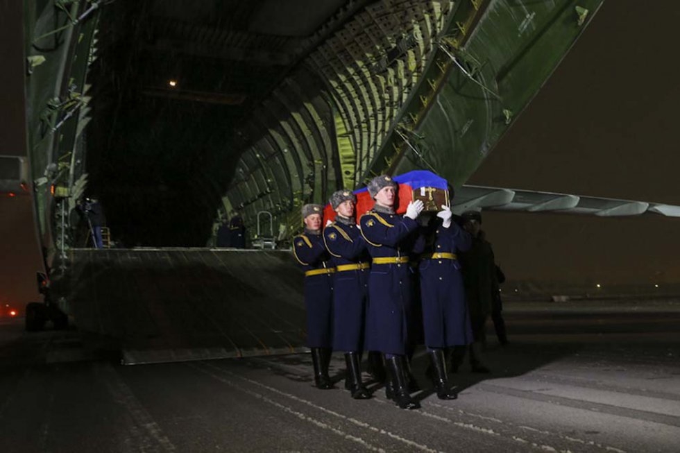Russian honour guards carry the coffin with the body of one of the pilots from the shot-down plane. Russian honour guards carry the coffin with the body of one of the pilots from the shot-down plane.