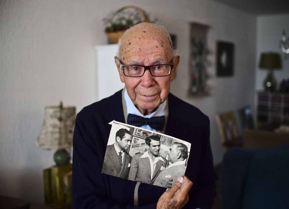 Don Neto holds a photo of himself Don Neto holds a photo of himself