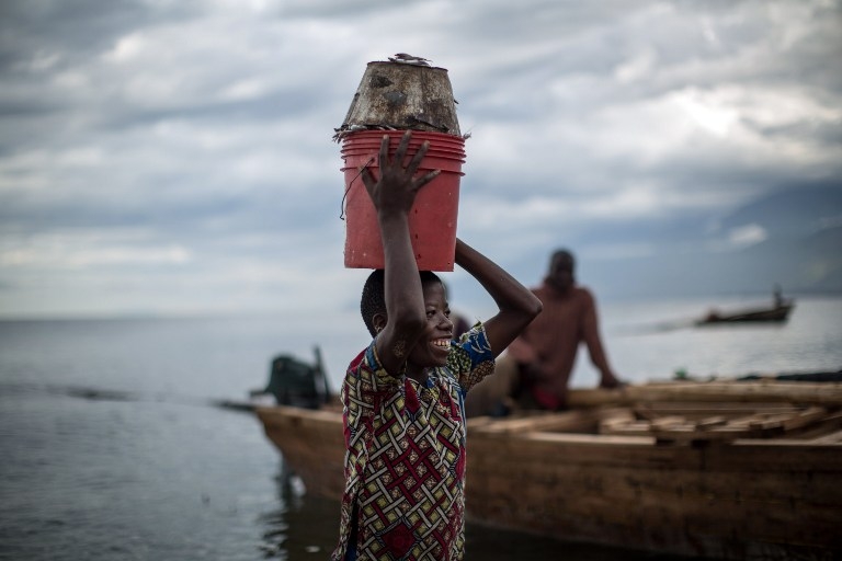 A child carries a bucket of fish in Uvira on the shores of Lake Tanganyika on March 22, 2015 A child carries a bucket of fish in Uvira on the shores of Lake Tanganyika on March 22, 2015