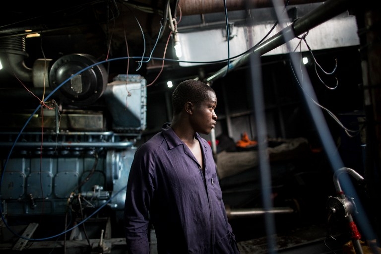 A mechanic in the engine room of a ferry on Lake Kivu on March 26, 2015 A mechanic in the engine room of a ferry on Lake Kivu on March 26, 2015
