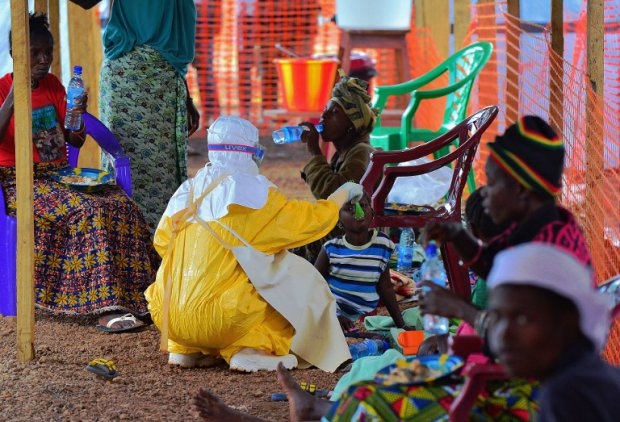 A medical worker feeds an Ebola child victim at an MSF facility in Kailahun, on August 15, 2014 A medical worker feeds an Ebola child victim at an MSF facility in Kailahun, on August 15, 2014