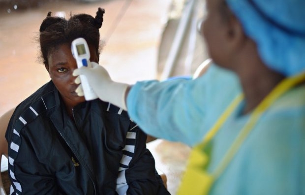 A girl suspected of being infected with the Ebola virus has her temperature checked at the government hospital in Kenema, Sierra Leone, on August 16, 2014 A girl suspected of being infected with the Ebola virus has her temperature checked at the government hospital in Kenema, Sierra Leone, on August 16, 2014