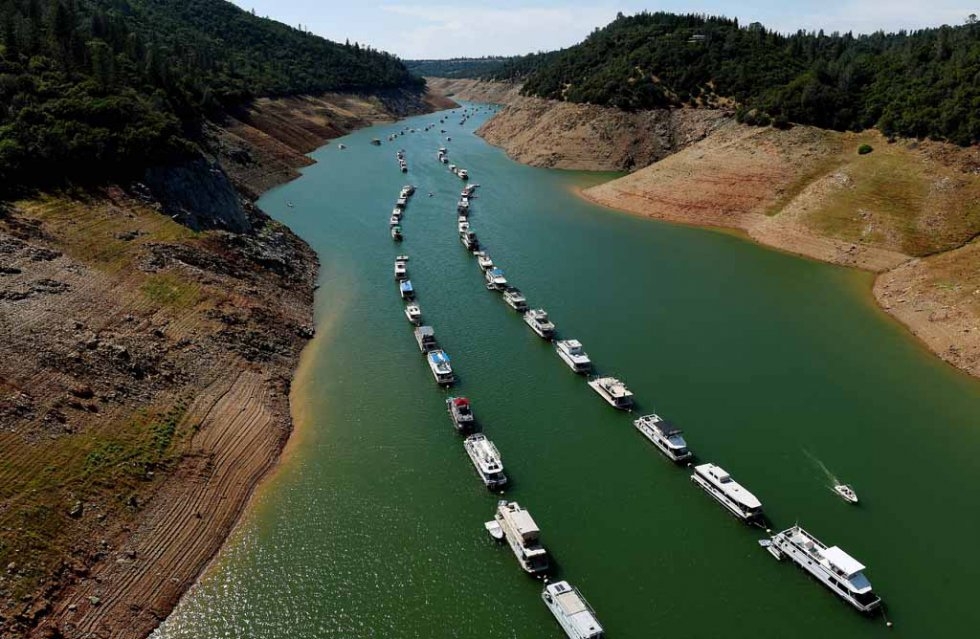 Houseboats are moored on a shrinking arm of a California lake. May, 2015. Houseboats are moored on a shrinking arm of a California lake. May, 2015.