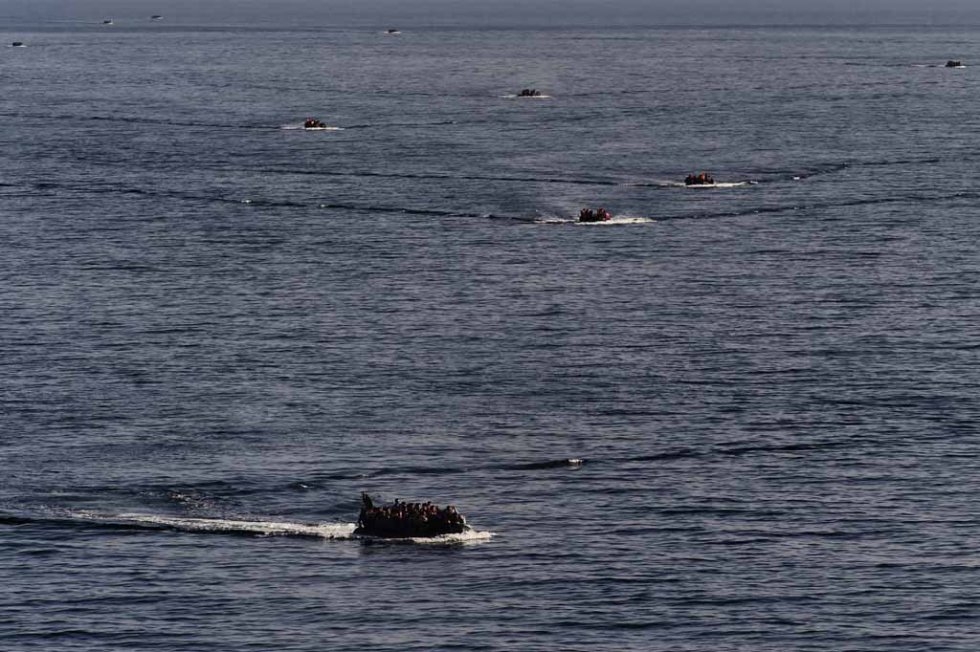 Dinghies filled with migrants approach the Greek island of Lesbos after crossing the Aegean Sea in early October. Dinghies filled with migrants approach the Greek island of Lesbos after crossing the Aegean Sea in early October.