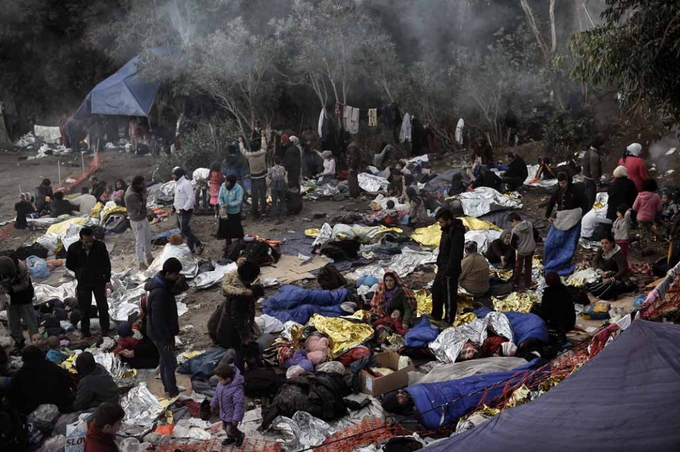 Refugees and migrants wake up after spending a night in a Lesbos field in early October. Refugees and migrants wake up after spending a night in a Lesbos field in early October.