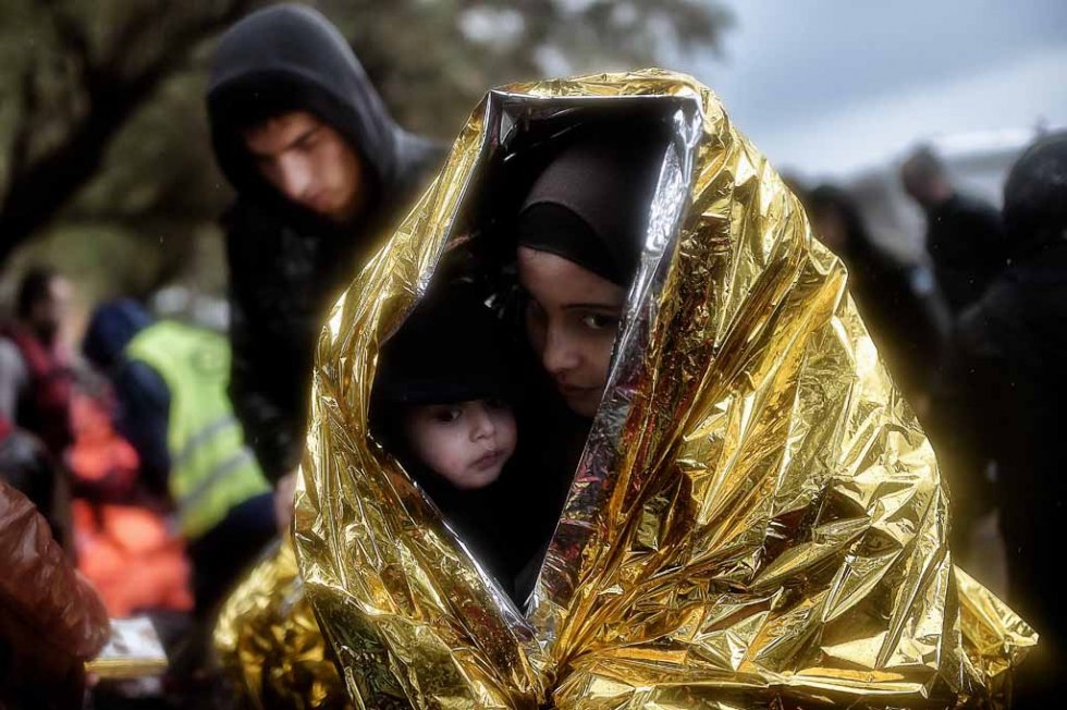 Children huddle under emergency blankets after arriving in Lesbos in October. (AFP/Aris Messinis) Children huddle under emergency blankets after arriving in Lesbos in October. (AFP/Aris Messinis)
