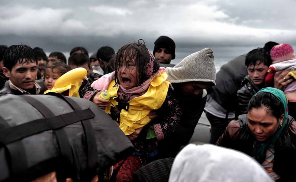A girl cries as she holds on to her baby bottle after arriving in Lesbos in late October. A girl cries as she holds on to her baby bottle after arriving in Lesbos in late October.