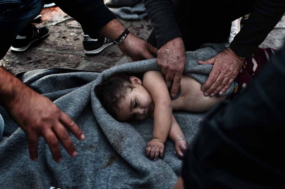Medics try to revive a baby who was on a boat that sunk near Lesbos in late October. Medics try to revive a baby who was on a boat that sunk near Lesbos in late October.